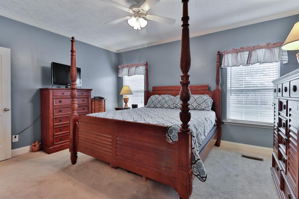 1045 Golf View Way Spring Hill, TN 37174 - Photo 16 of 26 a bedroom with a bed and a flat screen tv