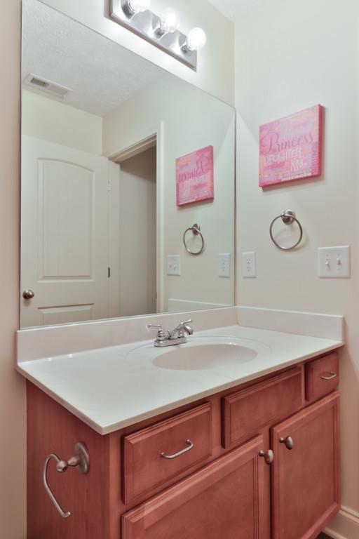 1045 Golf View Way Spring Hill, TN 37174 - Photo 20 of 26 a bathroom with a sink vanity and a mirror