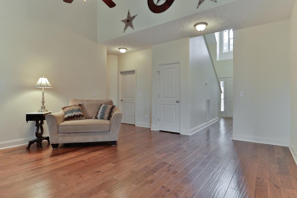 1045 Golf View Way Spring Hill, TN 37174 - Photo 6 of 26 a living room with furniture and a wooden floor