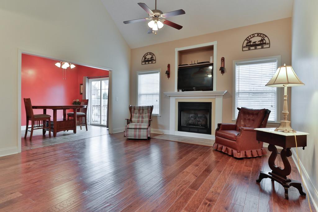 1045 Golf View Way Spring Hill, TN 37174 - Photo 7 of 26 a living room with furniture fireplace and flat screen tv