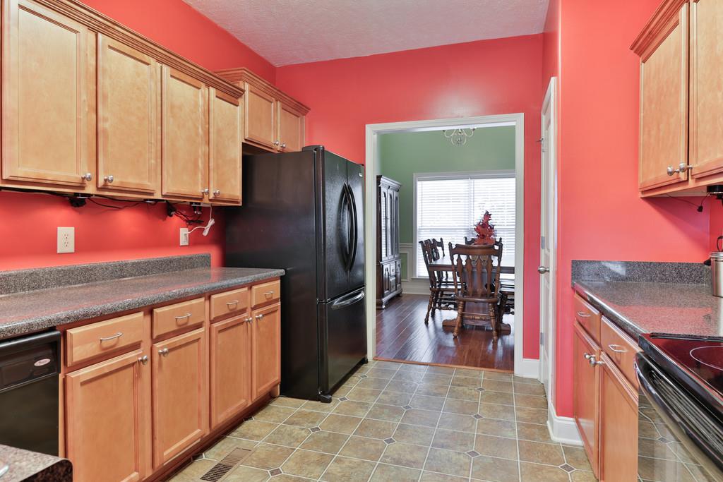 1045 Golf View Way Spring Hill, TN 37174 - Photo 10 of 26 a kitchen with stainless steel appliances granite countertop a refrigerator and a sink