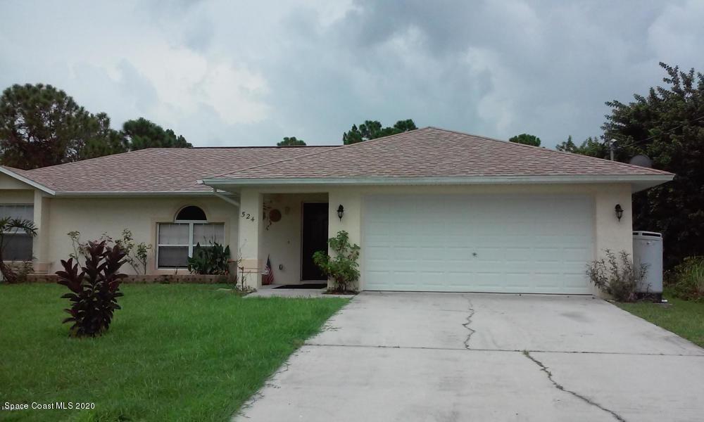 524 Titan Road Southeast Palm Bay, FL 32909 - Photo 1 of 18 a front view of a house with a yard