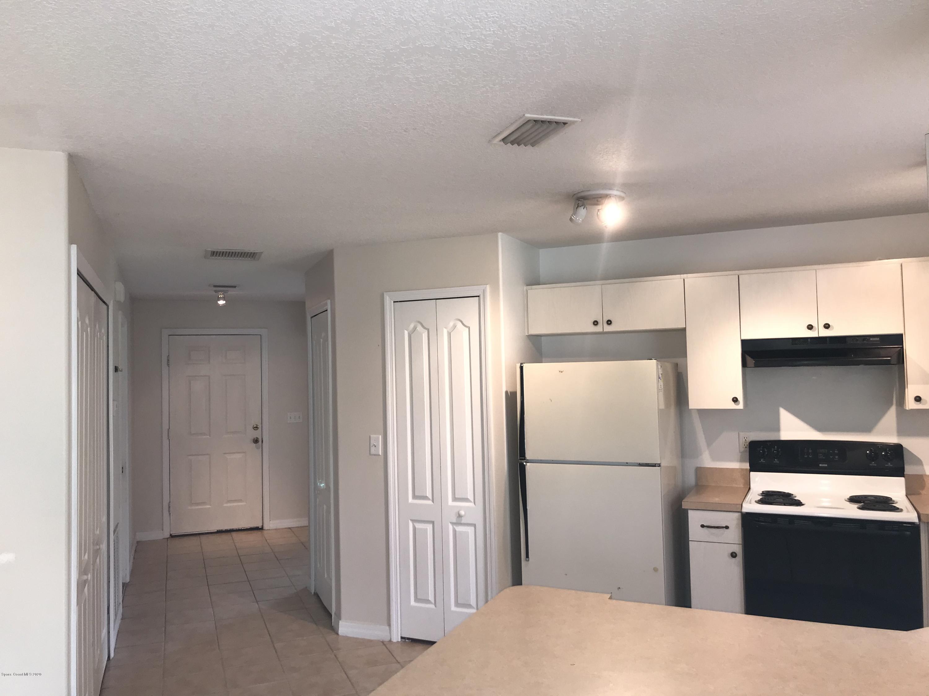 524 Titan Road Southeast Palm Bay, FL 32909 - Photo 2 of 18 a kitchen with a refrigerator a stove and a refrigerator