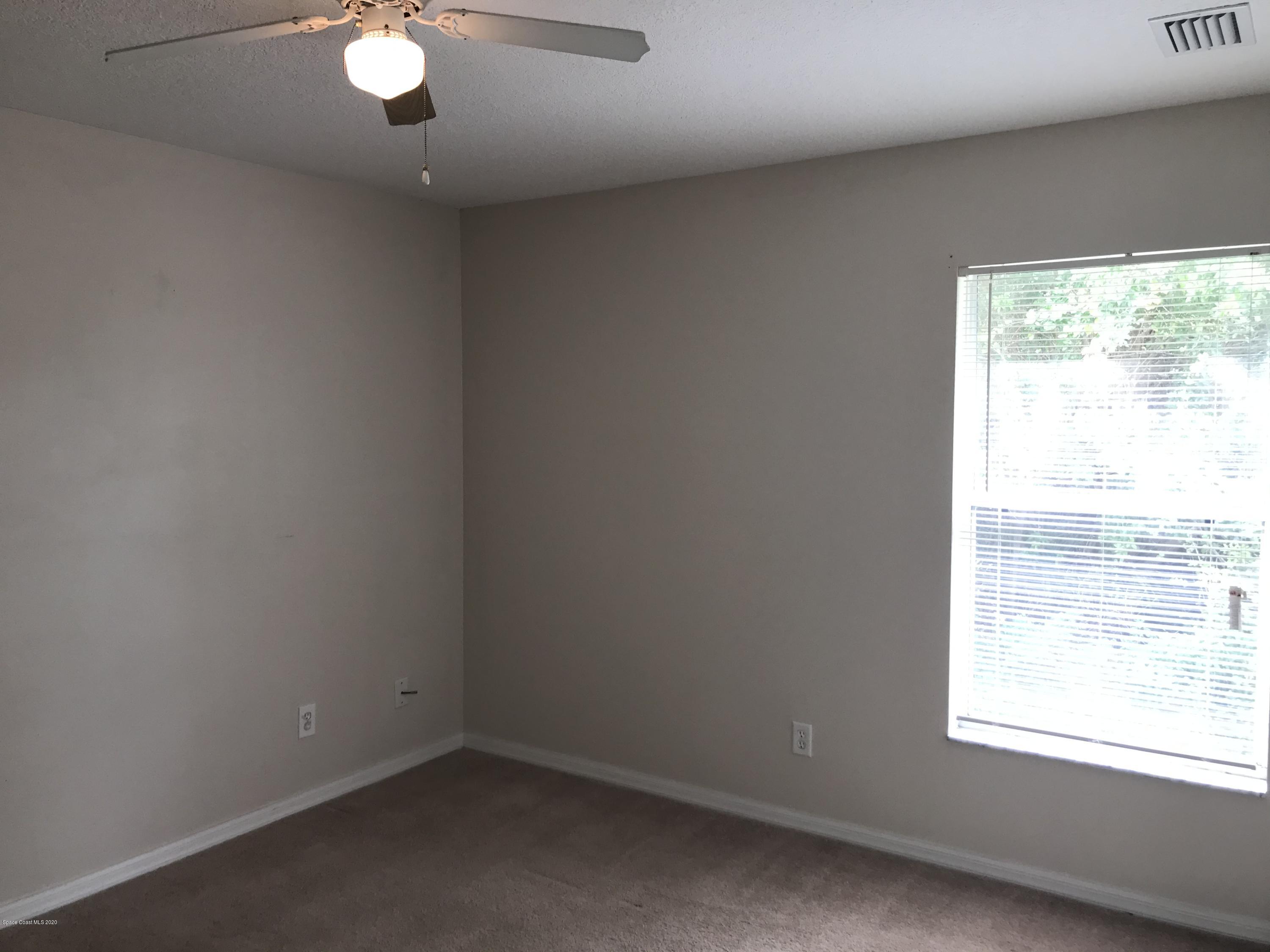 524 Titan Road Southeast Palm Bay, FL 32909 - Photo 13 of 18 an empty room with a window