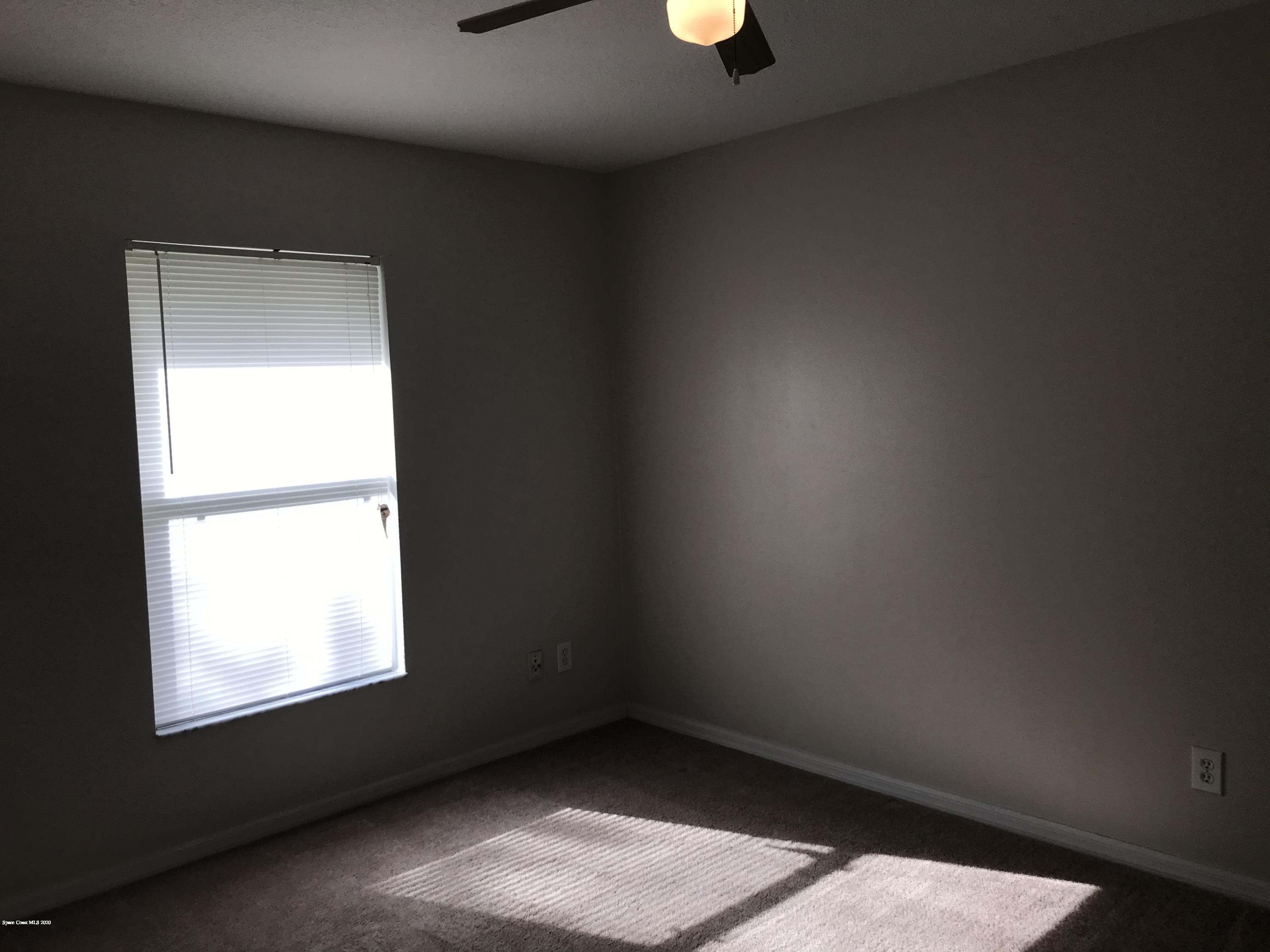 524 Titan Road Southeast Palm Bay, FL 32909 - Photo 15 of 18 an empty room with a window