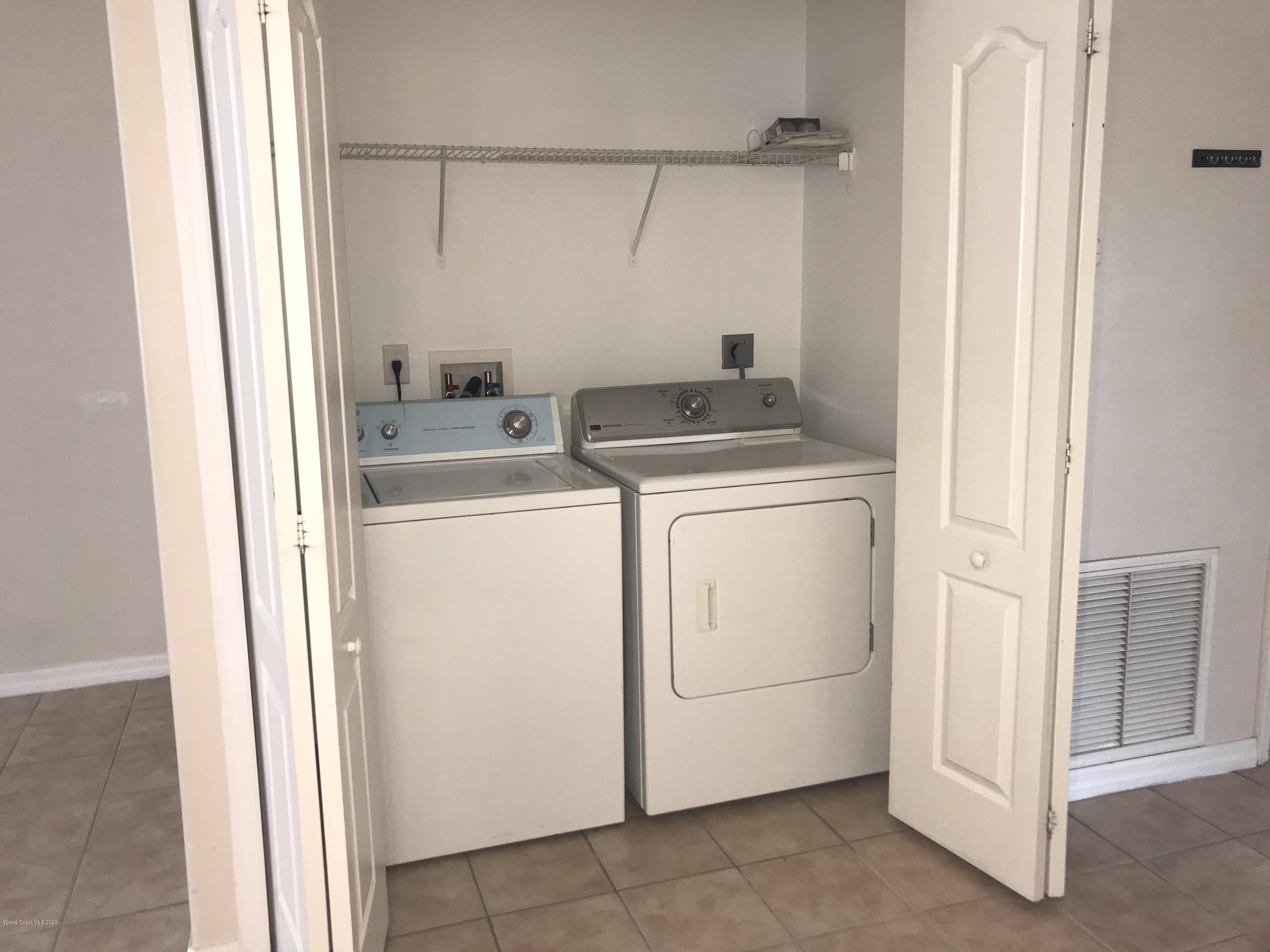 524 Titan Road Southeast Palm Bay, FL 32909 - Photo 16 of 18 a utility room with dryer and washer