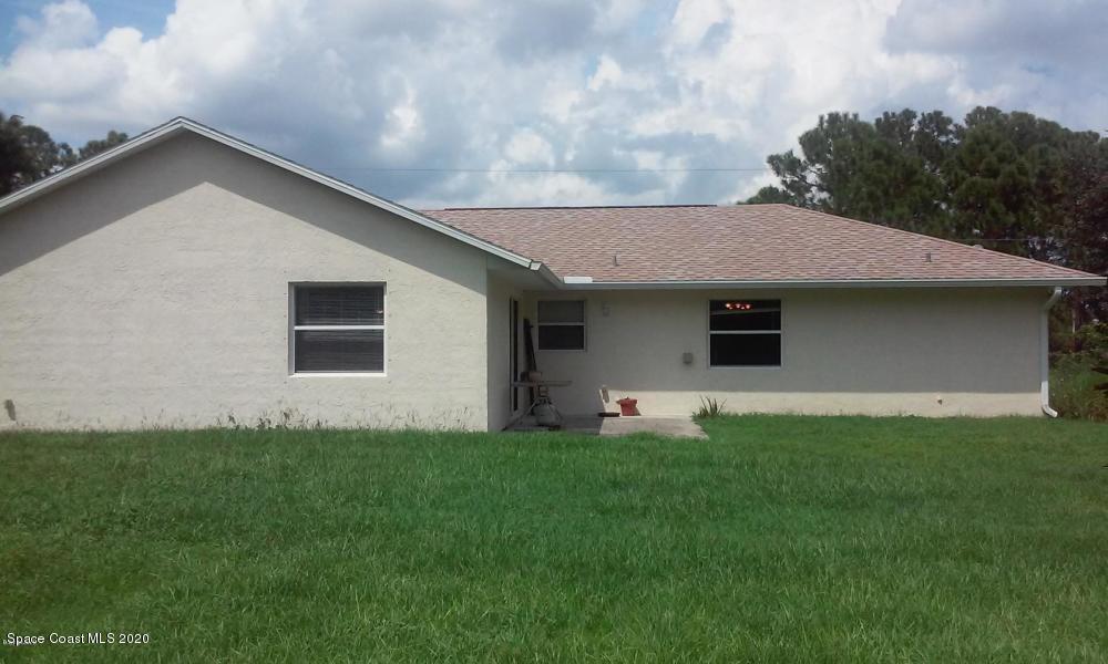 524 Titan Road Southeast Palm Bay, FL 32909 - Photo 17 of 18 a front view of a house with a yard and garage