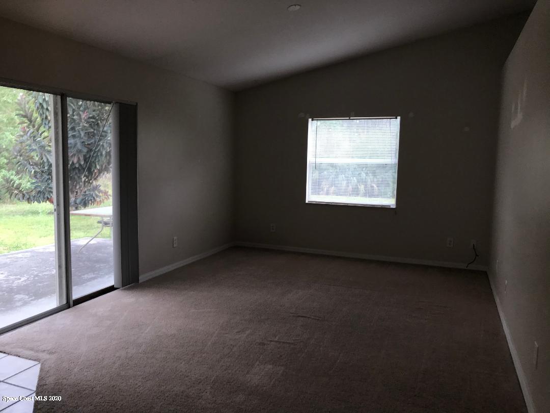 524 Titan Road Southeast Palm Bay, FL 32909 - Photo 8 of 18 a view of an empty room with a window