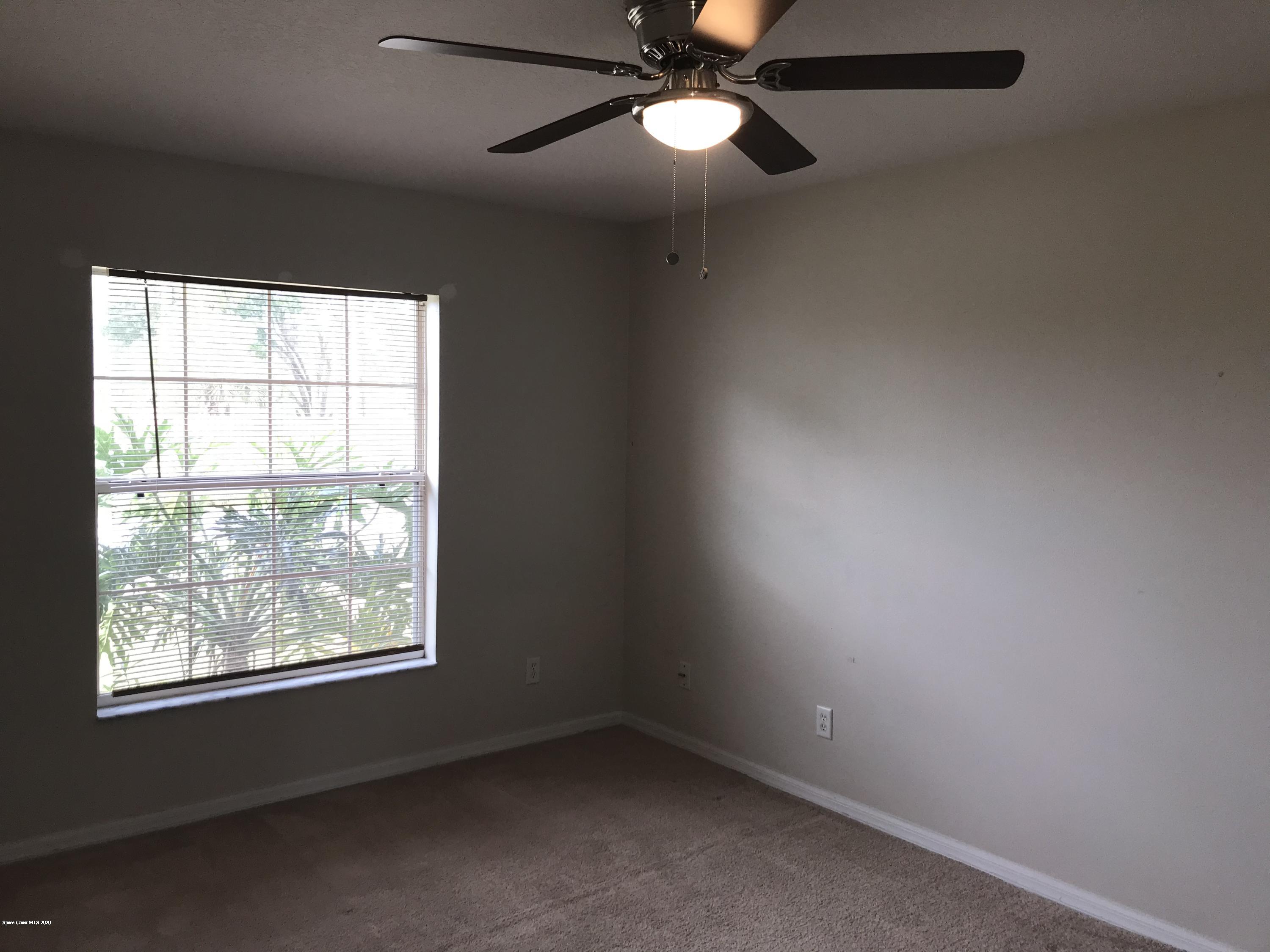 524 Titan Road Southeast Palm Bay, FL 32909 - Photo 9 of 18 an empty room with a window and a fan