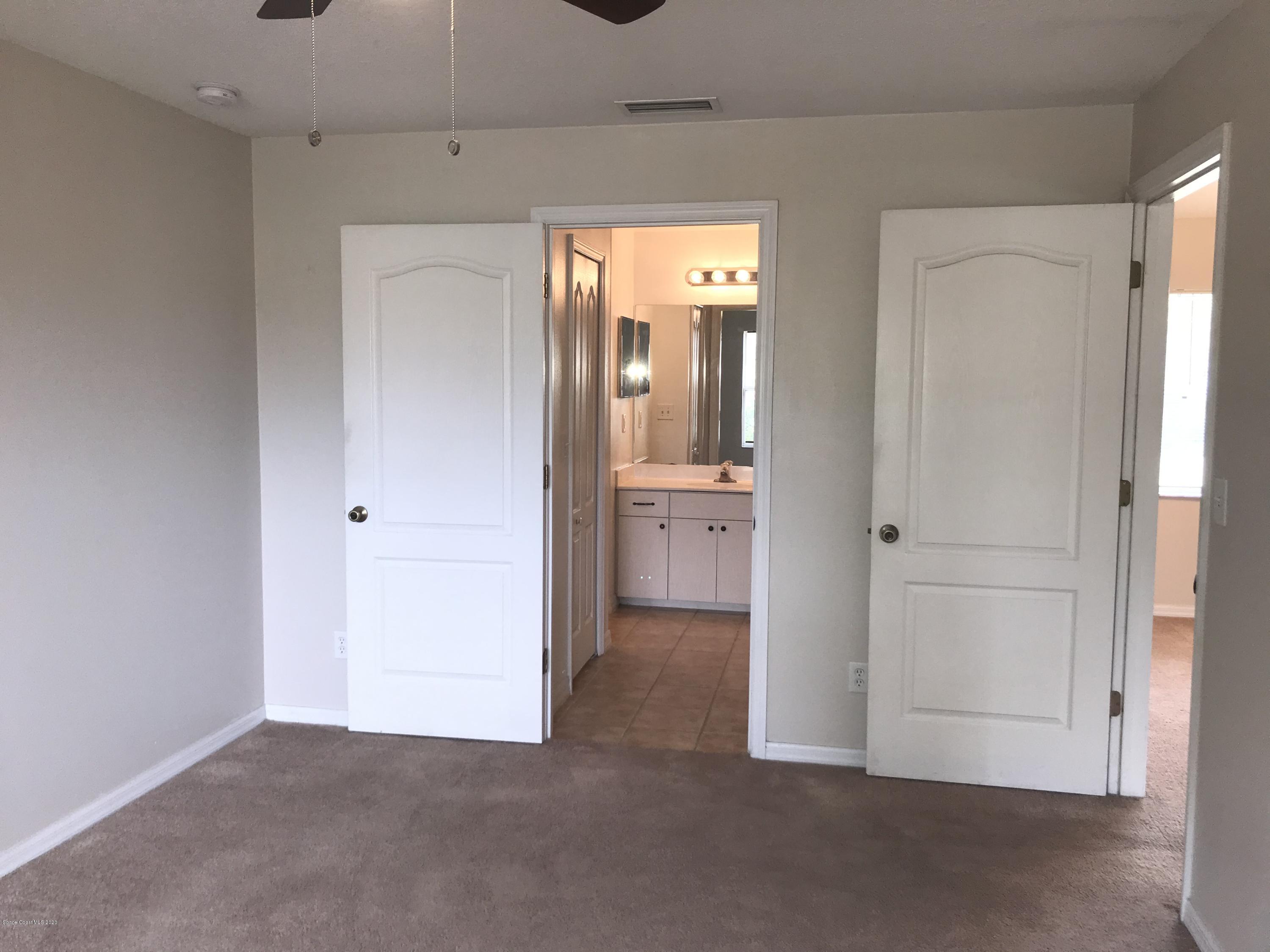 524 Titan Road Southeast Palm Bay, FL 32909 - Photo 10 of 18 an empty room with windows