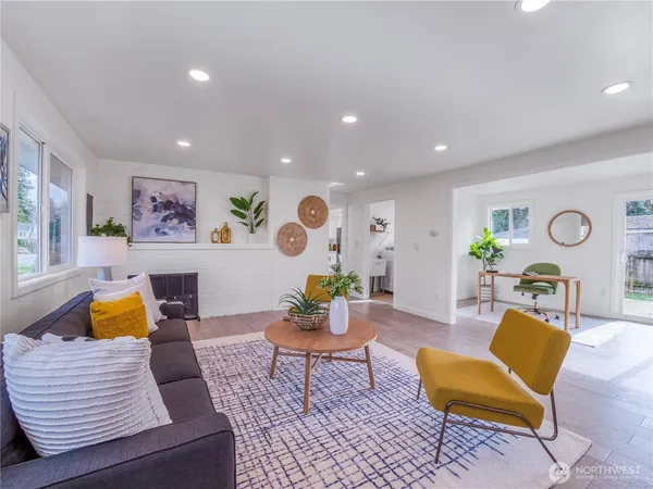 a living room with furniture and wooden floor