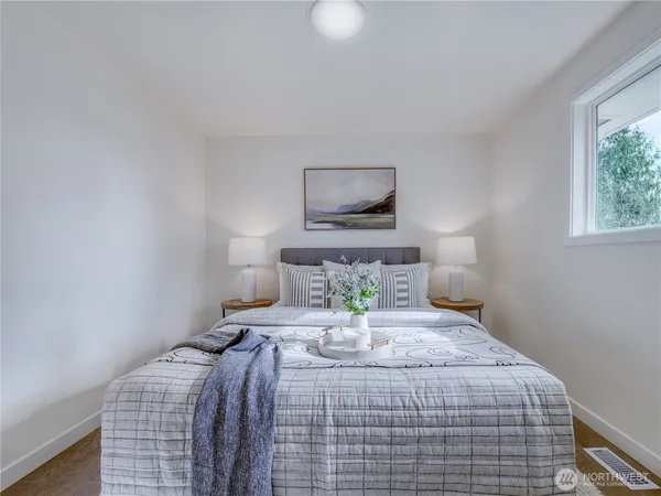 a bedroom with a bed and a lamp