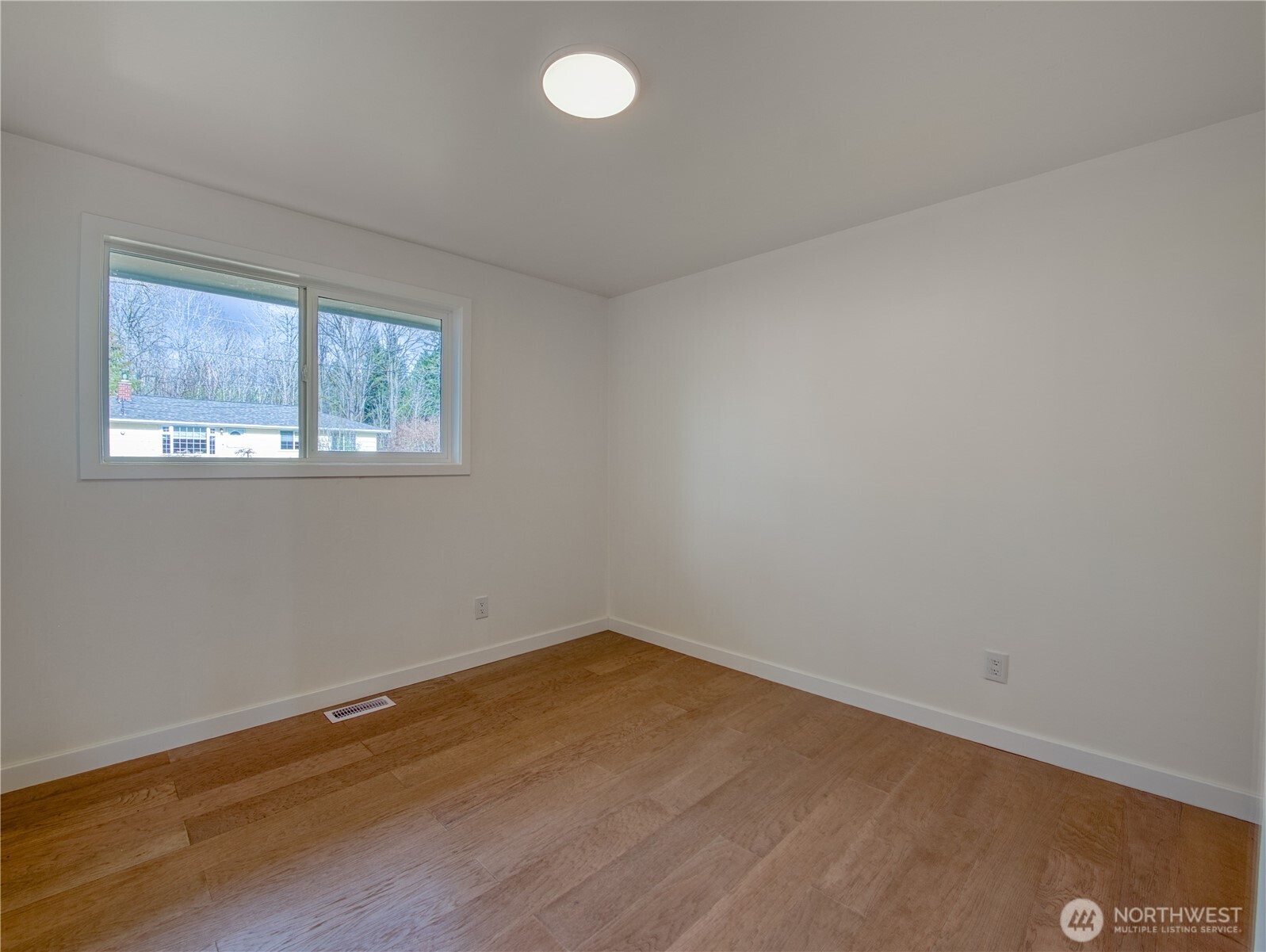 18 232nd Place Southwest Bothell, WA 98021 - Photo 20 of 32 an empty room with wooden floor and windows