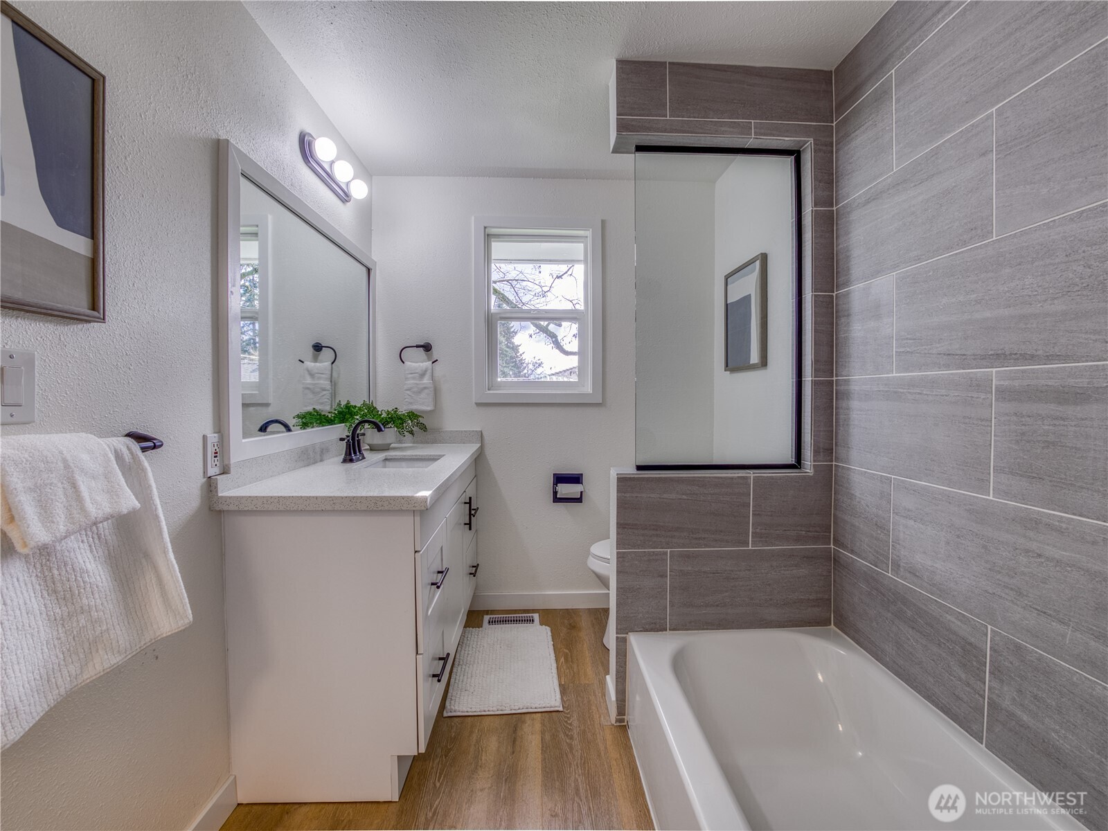 18 232nd Place Southwest Bothell, WA 98021 - Photo 24 of 32 a bathroom with a bathtub a sink and a mirror