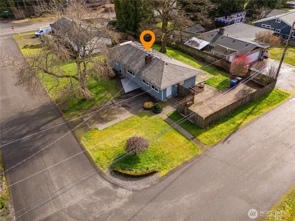 an aerial view of a house with a yard basket ball court and outdoor seating