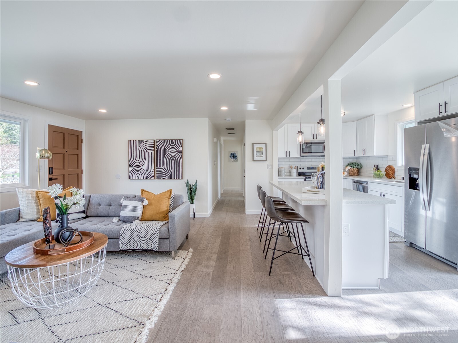 18 232nd Place Southwest Bothell, WA 98021 - Photo 6 of 32 a living room with furniture and a dining table with kitchen view