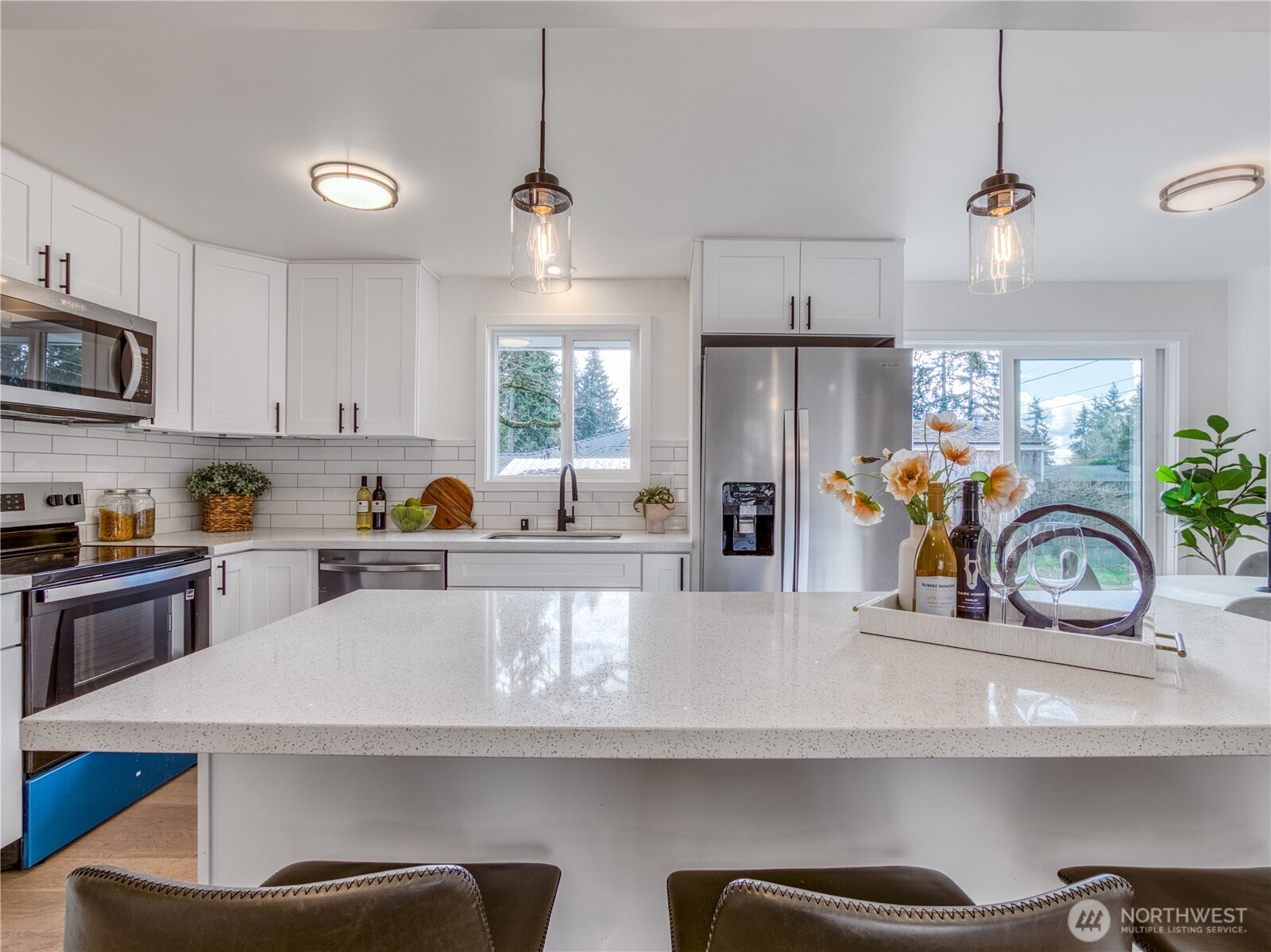 18 232nd Place Southwest Bothell, WA 98021 - Photo 7 of 32 a kitchen with stainless steel appliances granite countertop a sink a stove and a refrigerator