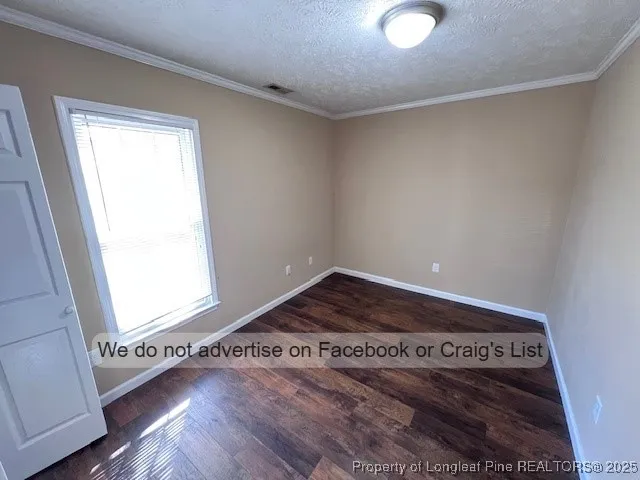 a view of an empty room and wooden floor