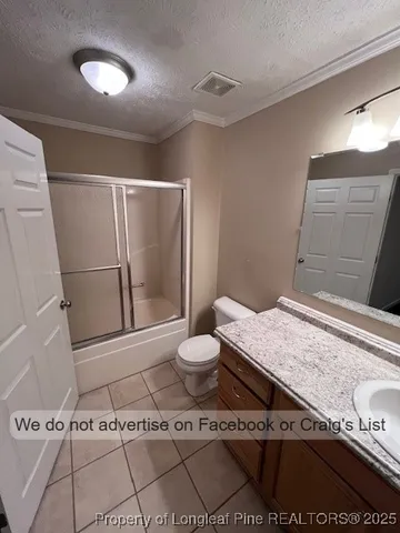 a bathroom with a granite countertop sink a toilet and a mirror