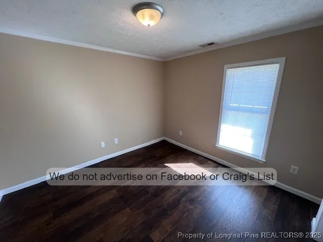 a view of an empty room and wooden floor