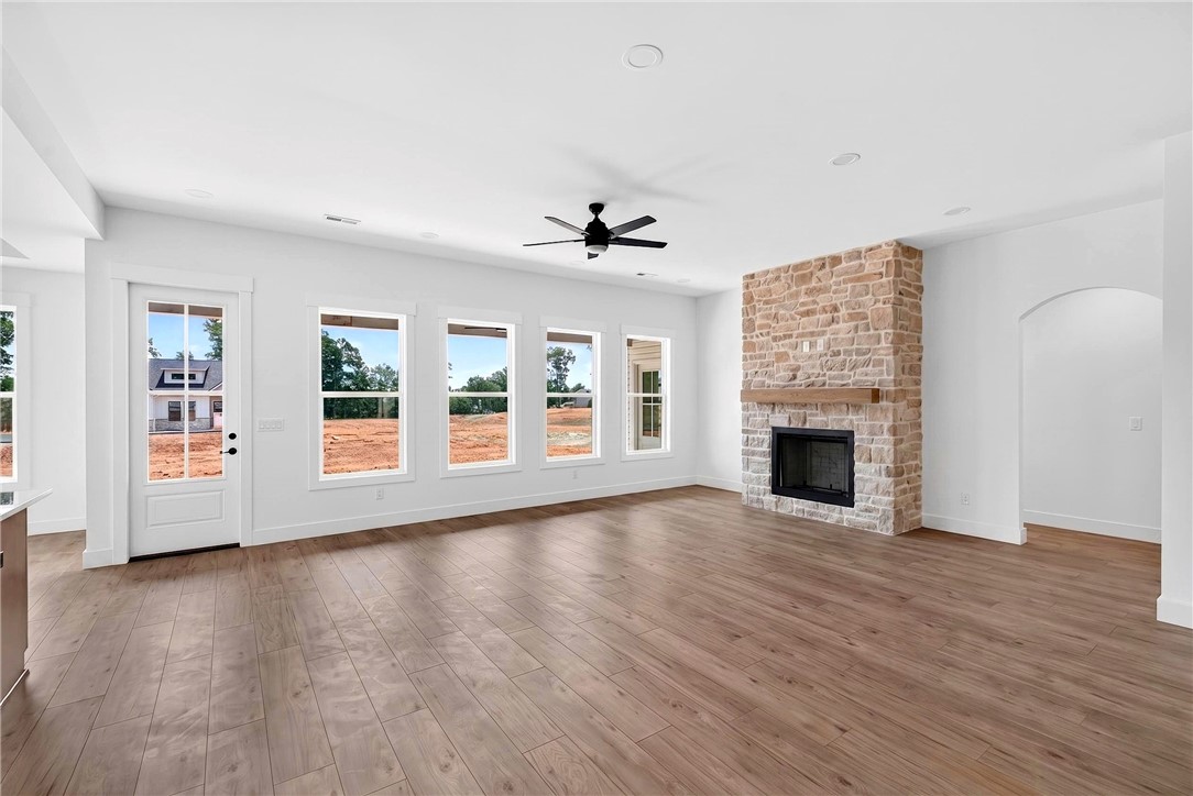 424 Blume Road Anderson, SC 29625 - Photo 7 of 30 A spacious, naturally illuminated great room boasts wood flooring and a floor-to-ceiling stone fireplace.