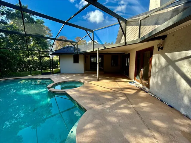 a view of a house with backyard and porch