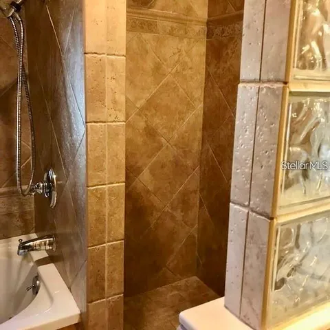 a bathroom with a toilet and shower