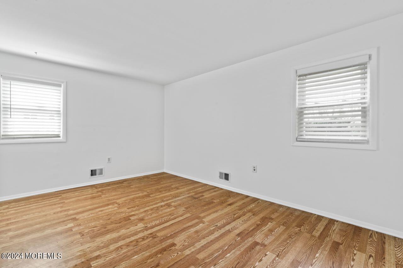 601 Mistletoe Avenue, Unit 4 Point Pleasant, NJ 08742 - Photo 23 of 28 a view of empty room with wooden floor and fan