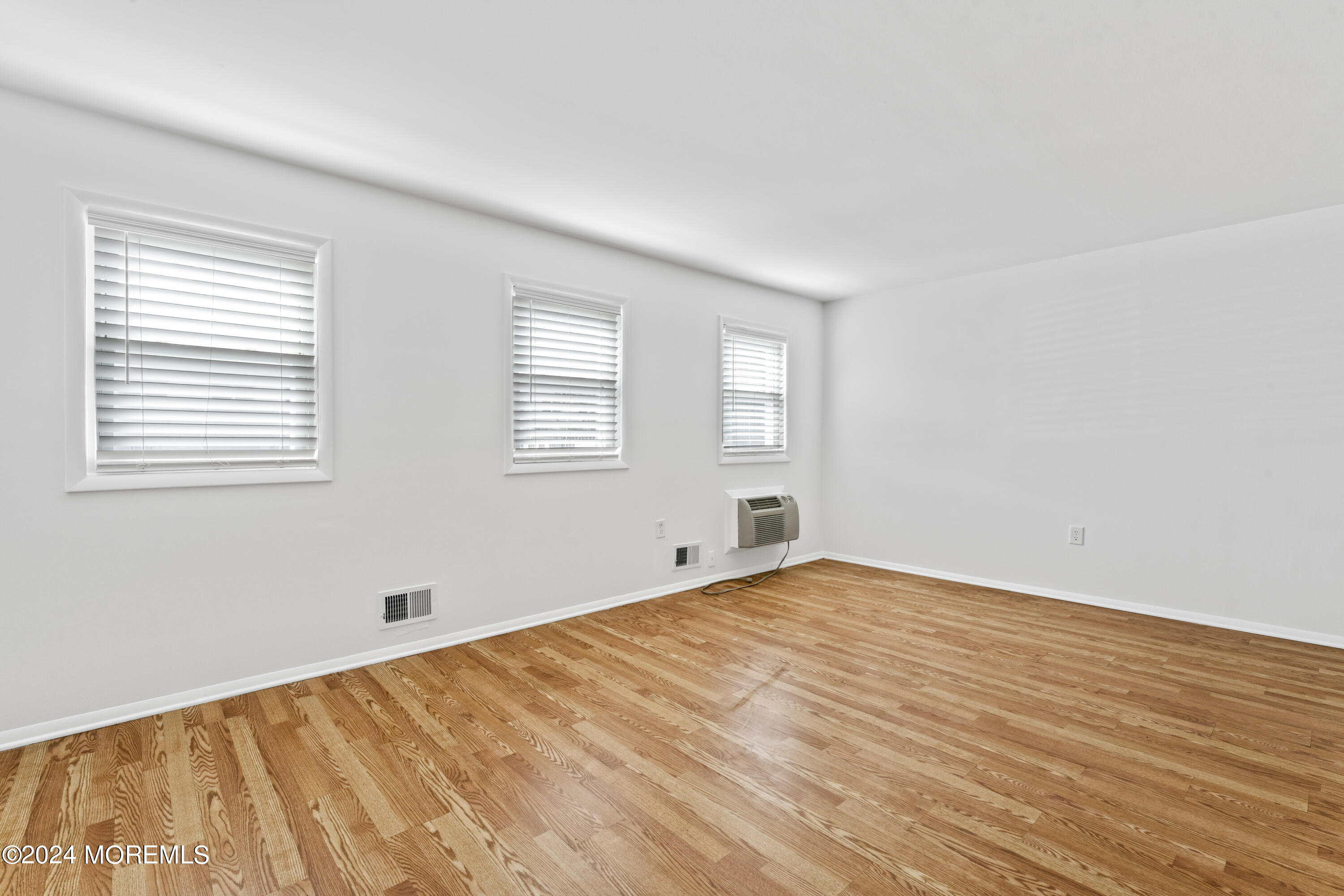 601 Mistletoe Avenue, Unit 4 Point Pleasant, NJ 08742 - Photo 5 of 28 a view of empty room with wooden floor and fan