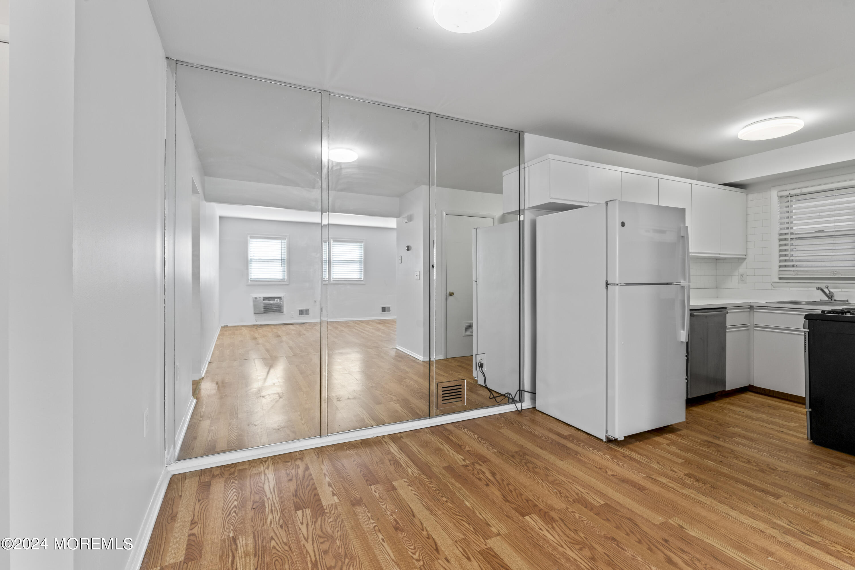 601 Mistletoe Avenue, Unit 4 Point Pleasant, NJ 08742 - Photo 8 of 28 a view of a kitchen with a fridge and wooden floor