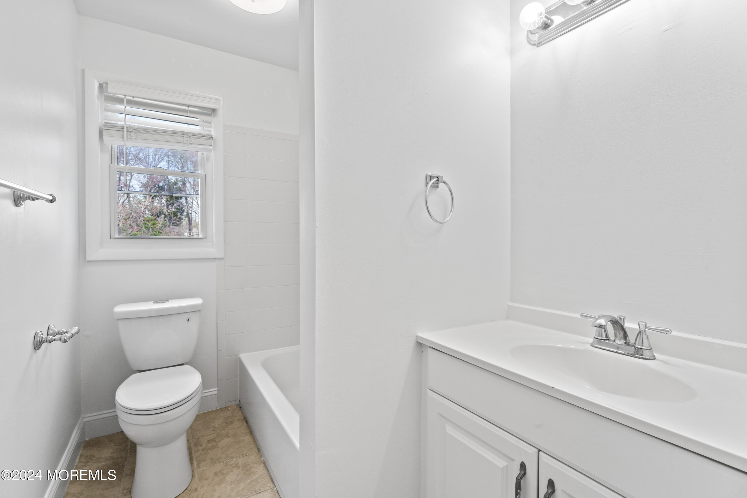 601 Mistletoe Avenue, Unit 4 Point Pleasant, NJ 08742 - Photo 9 of 28 a bathroom with a toilet sink and mirror