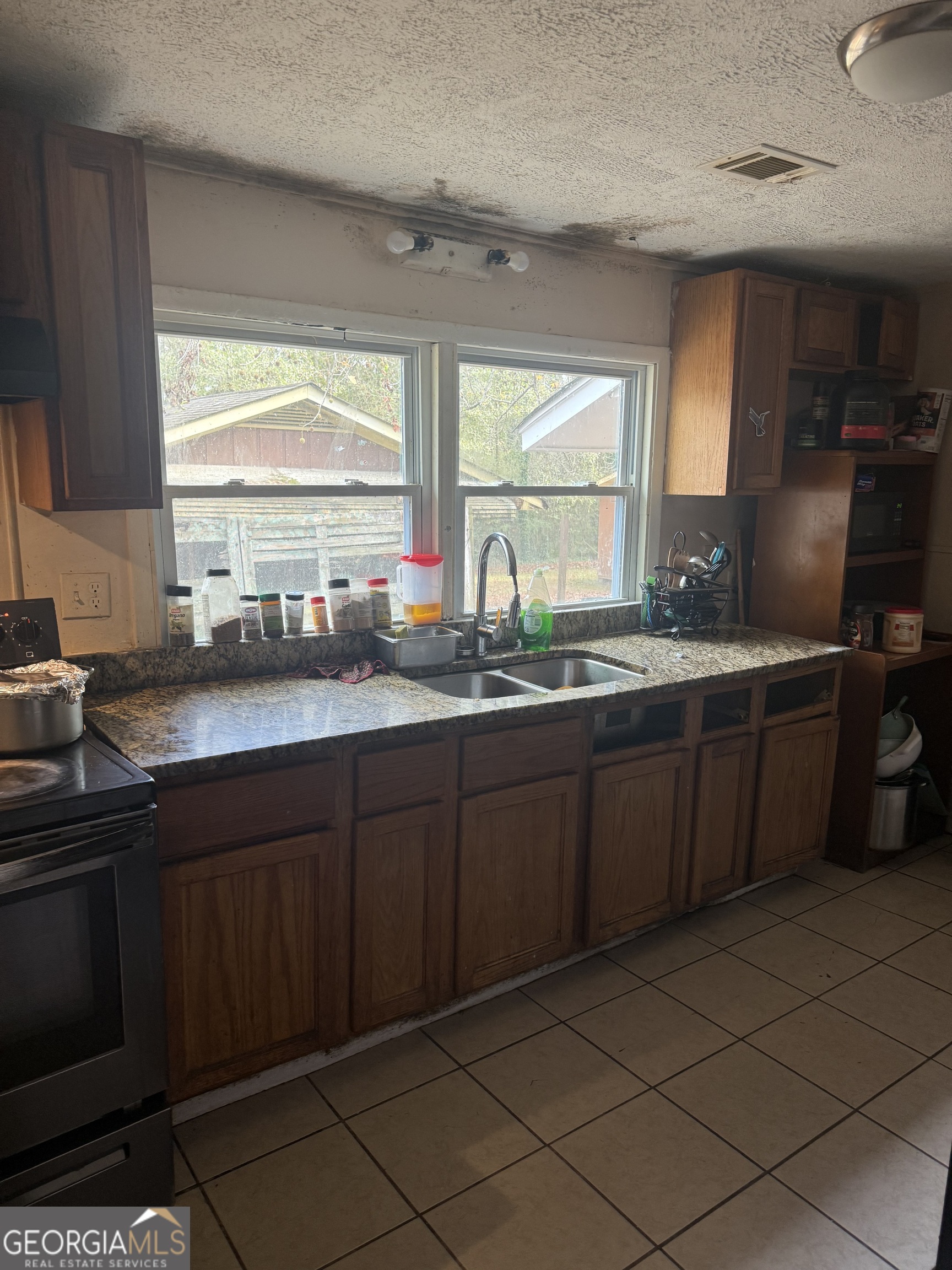 59 Berry Avenue Newnan, GA 30263 - Photo 4 of 7 a kitchen with a sink and cabinets