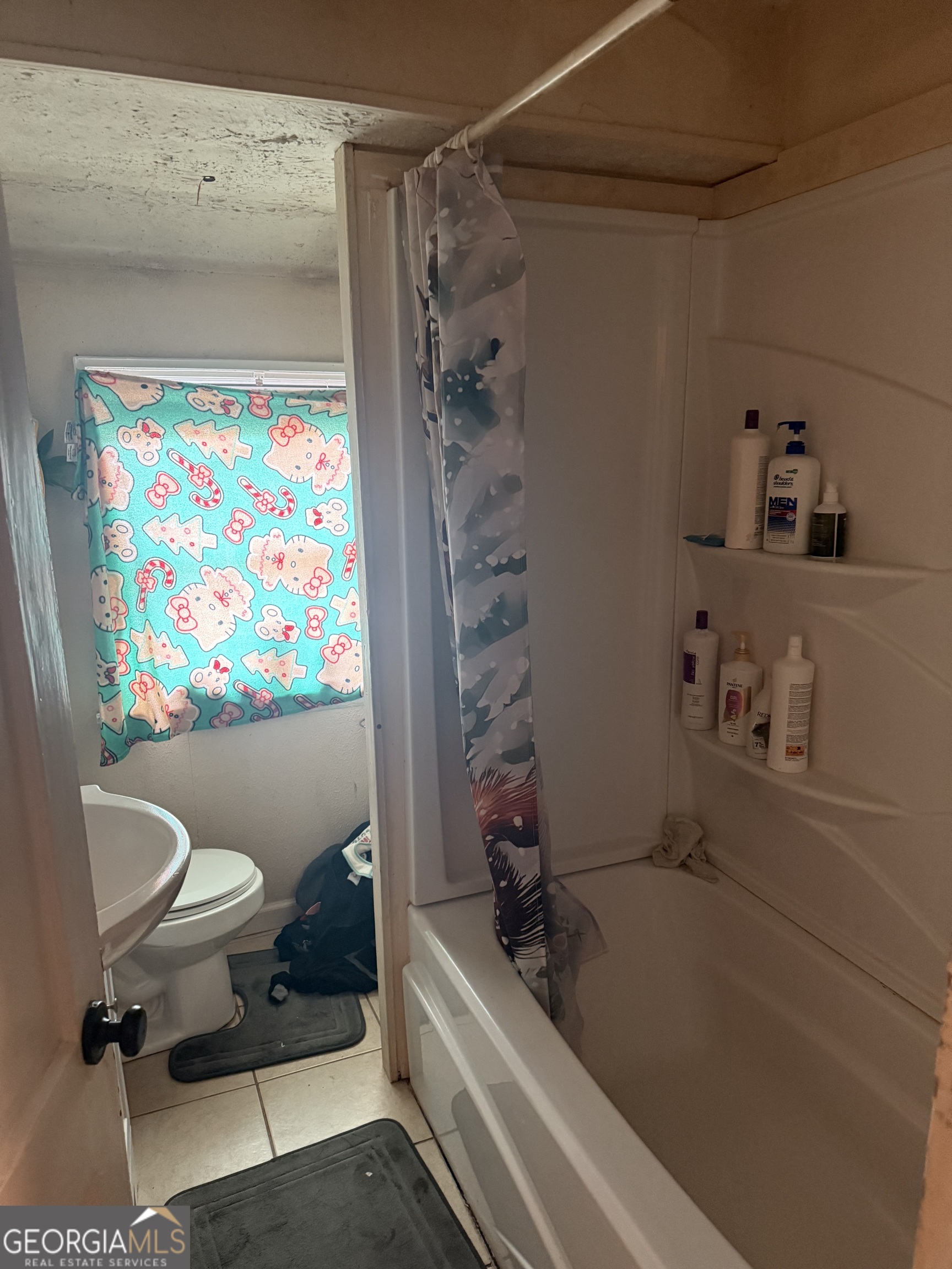 59 Berry Avenue Newnan, GA 30263 - Photo 5 of 7 a bathroom with a bathtub and a shower