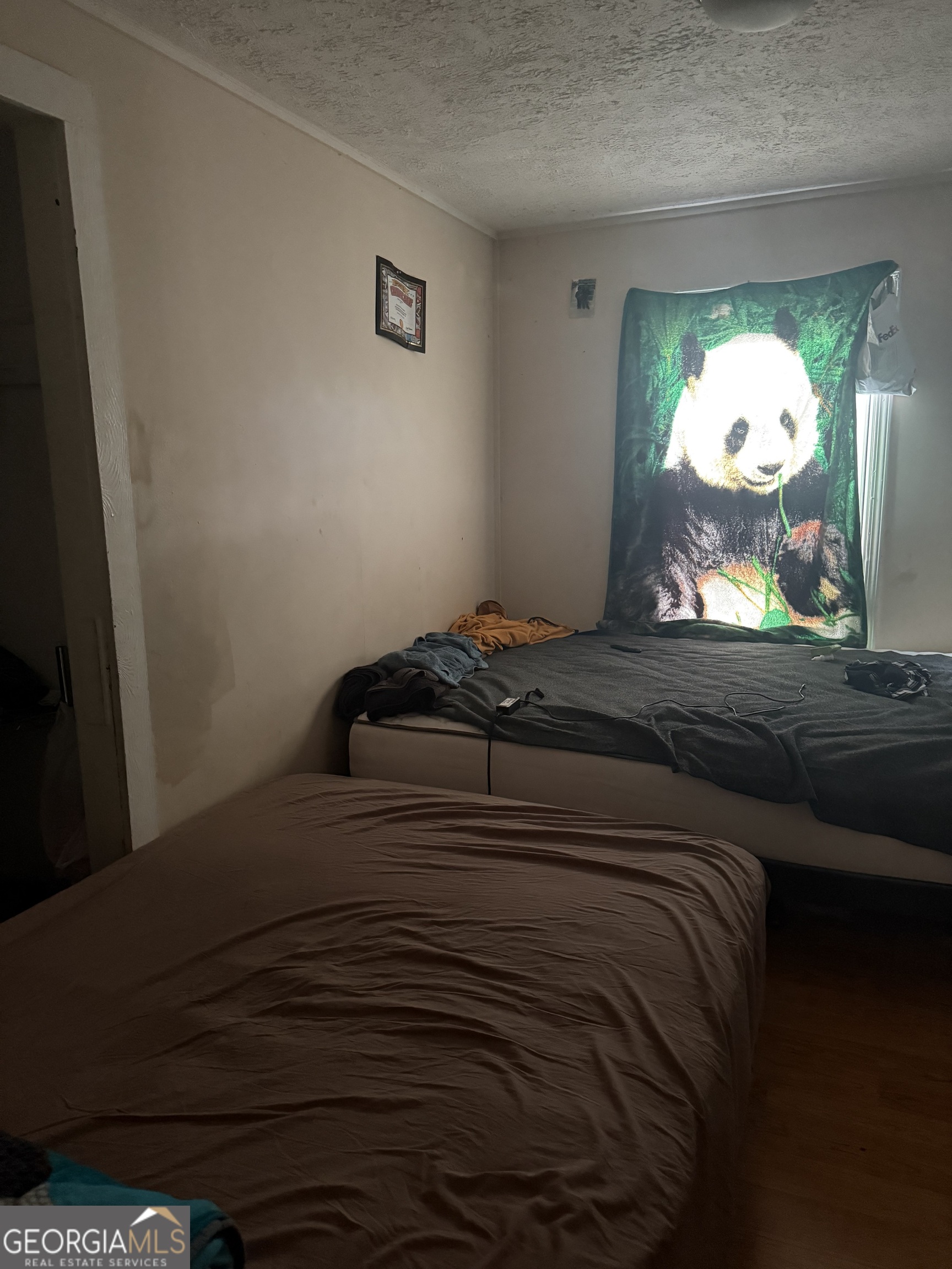 59 Berry Avenue Newnan, GA 30263 - Photo 7 of 7 a bedroom with a bed and painting on the wall