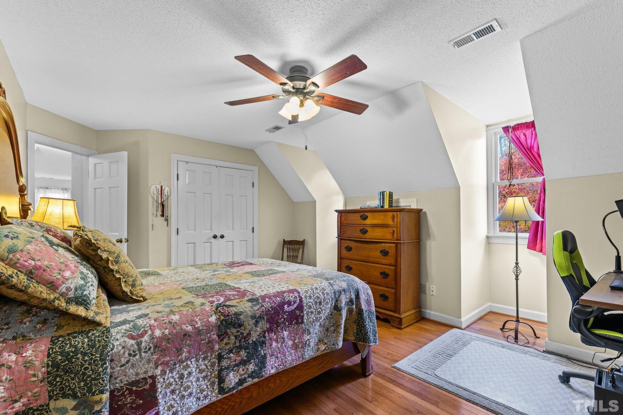 924 Windrow Lane Raleigh, NC 27603 - Photo 11 of 26 a bedroom with a bed and a chandelier