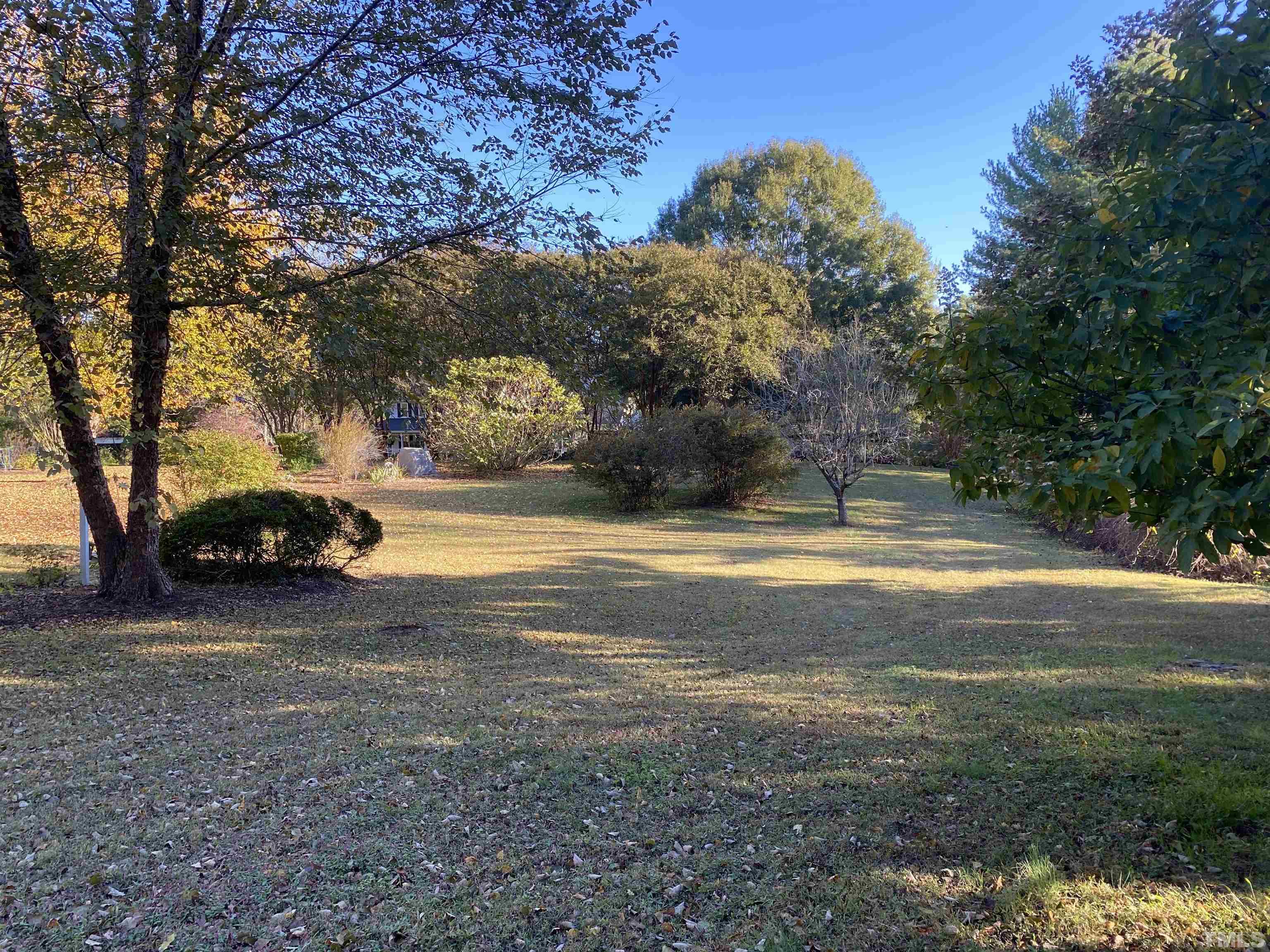 924 Windrow Lane Raleigh, NC 27603 - Photo 5 of 26 a view of yard with swimming pool and trees
