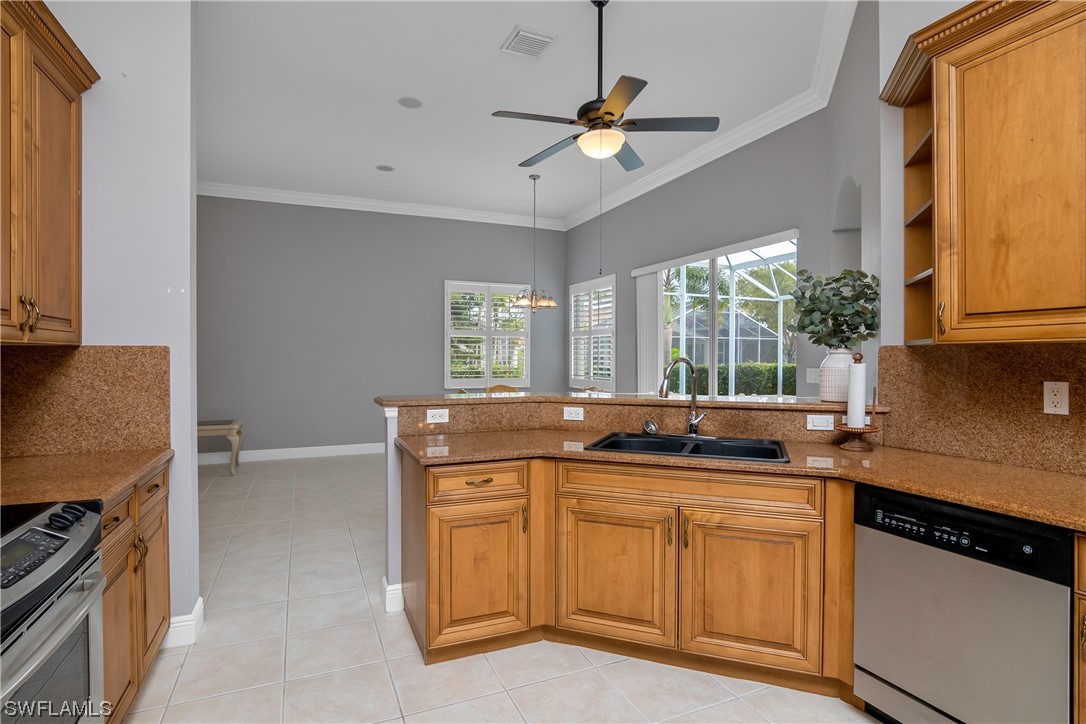 9057 Whitfield Drive Estero, FL 33928 - Photo 11 of 28 a kitchen with a sink and a stove