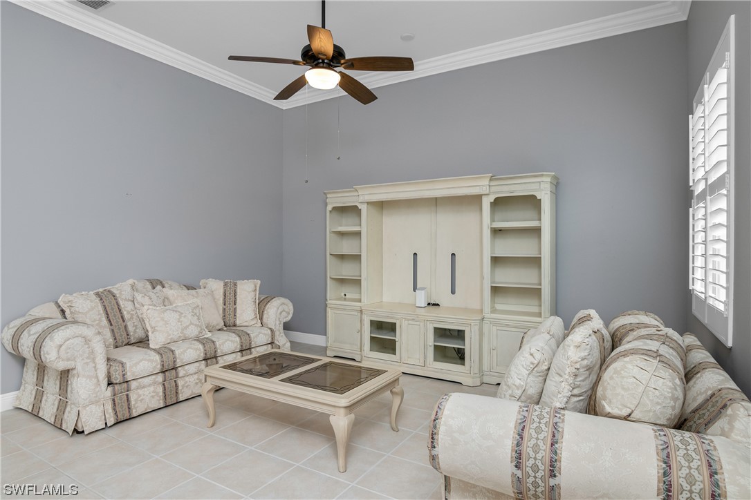 9057 Whitfield Drive Estero, FL 33928 - Photo 14 of 28 a living room with furniture ceiling fan and a window