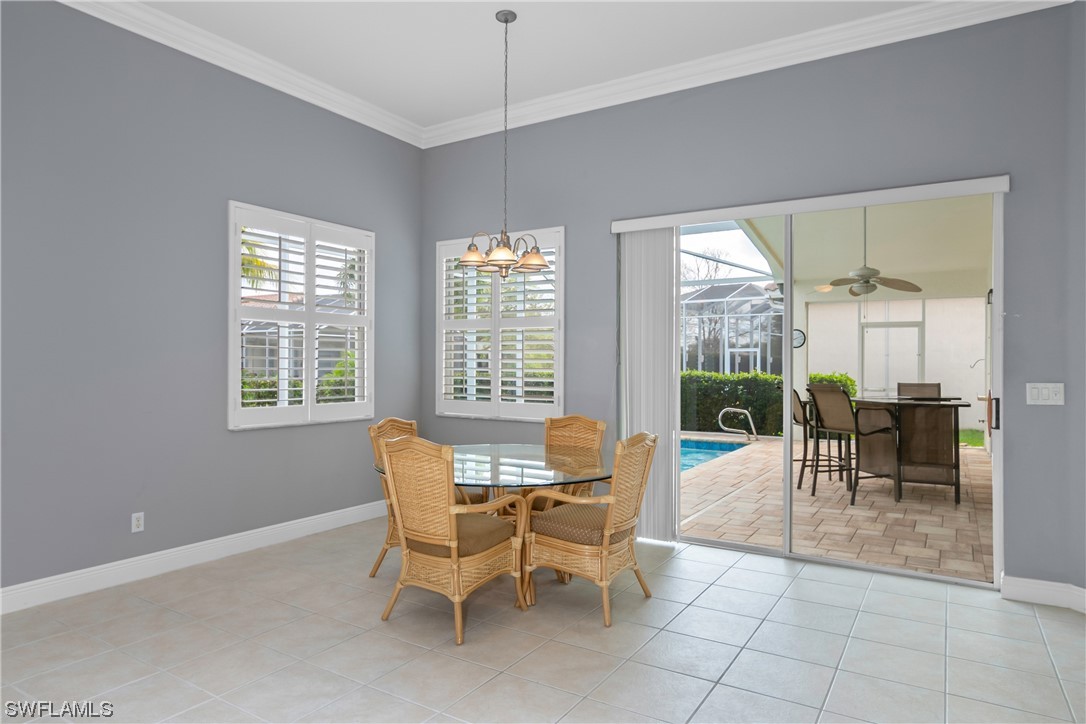 9057 Whitfield Drive Estero, FL 33928 - Photo 15 of 28 a dining room with furniture and large windows