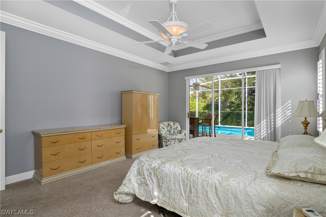 9057 Whitfield Drive Estero, FL 33928 - Photo 17 of 28 a large bed sitting in a bedroom next to a window