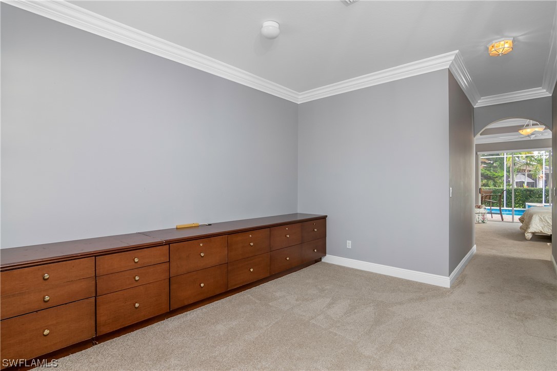 9057 Whitfield Drive Estero, FL 33928 - Photo 18 of 28 a room with a dresser and a window
