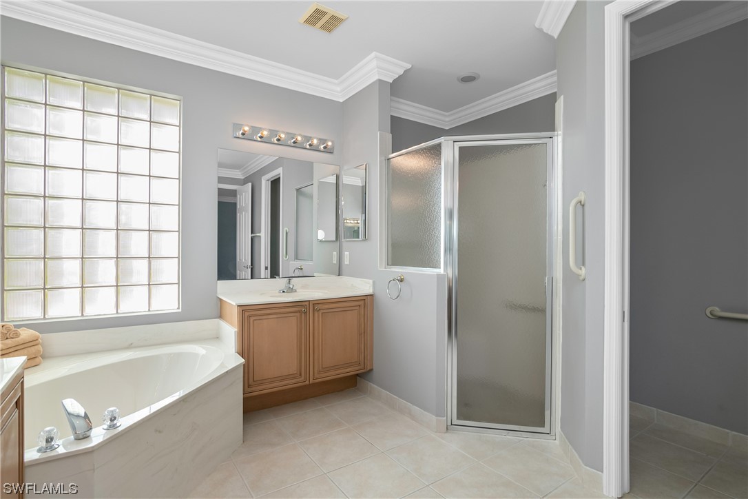 9057 Whitfield Drive Estero, FL 33928 - Photo 20 of 28 a bathroom with a tub a sink and mirror