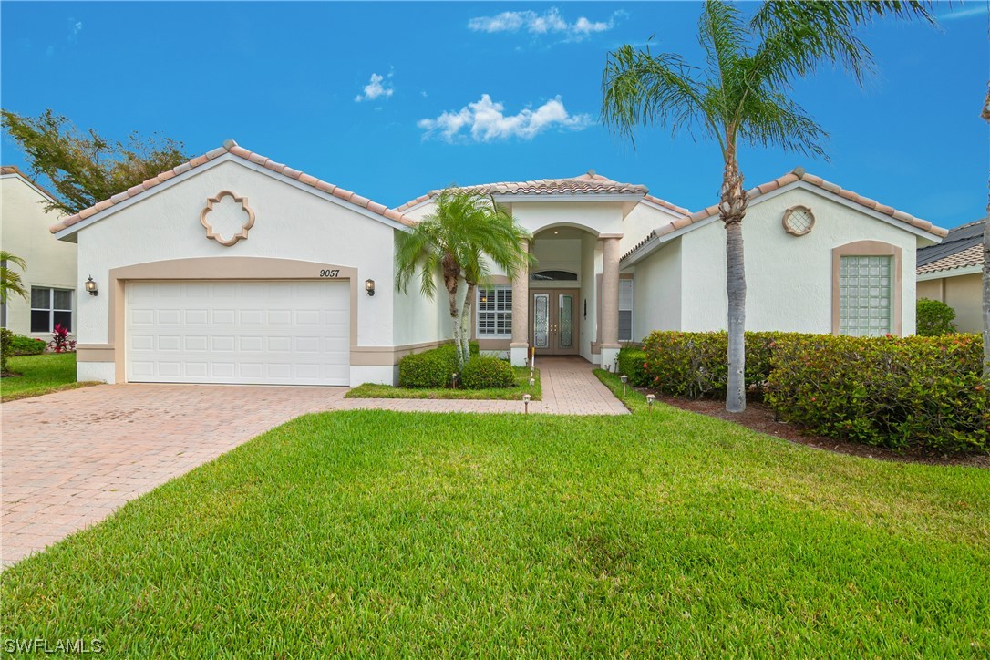 9057 Whitfield Drive Estero, FL 33928 - Photo 2 of 28 a view of a house with a yard and potted plants
