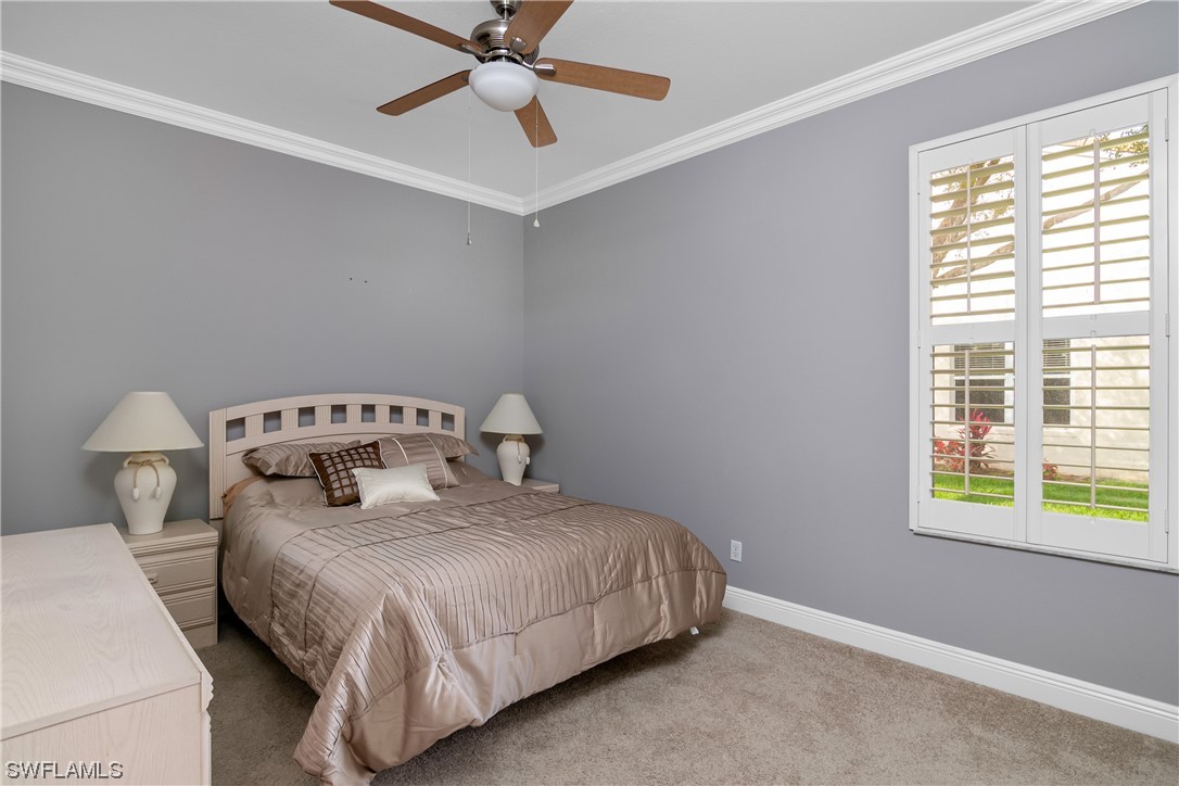 9057 Whitfield Drive Estero, FL 33928 - Photo 21 of 28 a bedroom with a bed and window