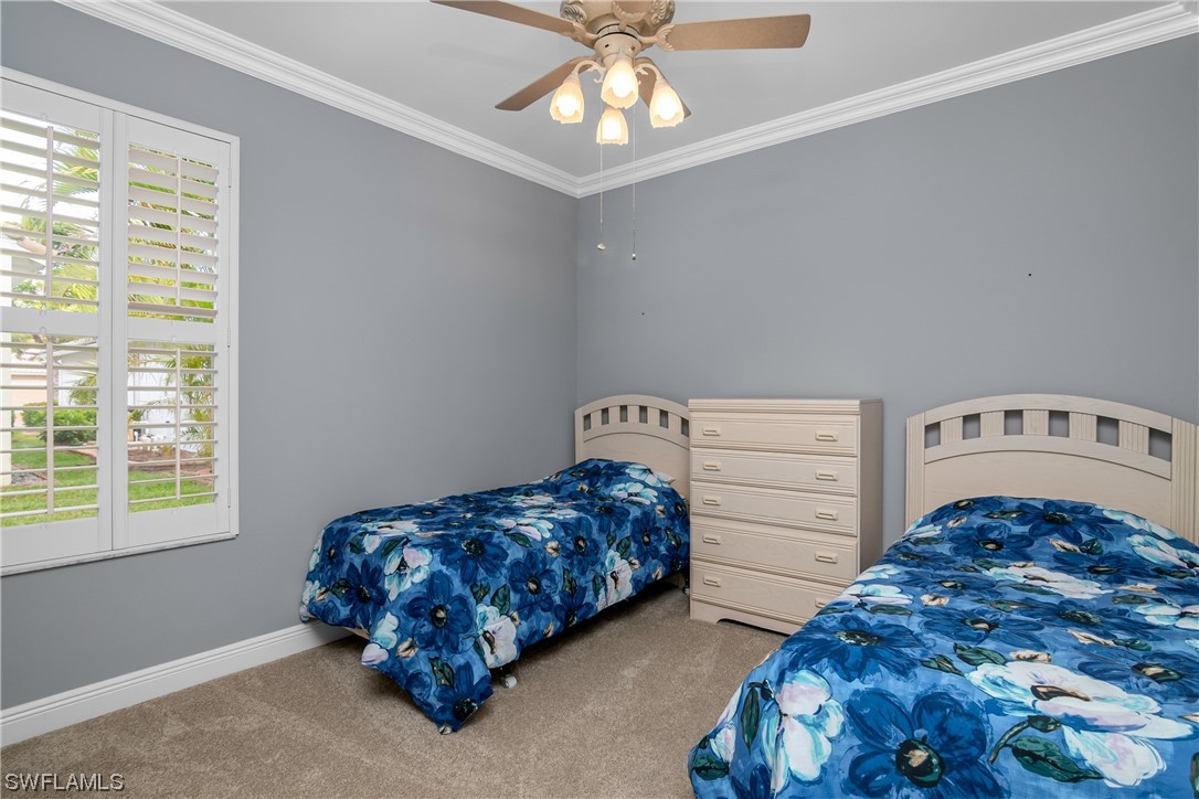 9057 Whitfield Drive Estero, FL 33928 - Photo 23 of 28 a bedroom with bed and a window