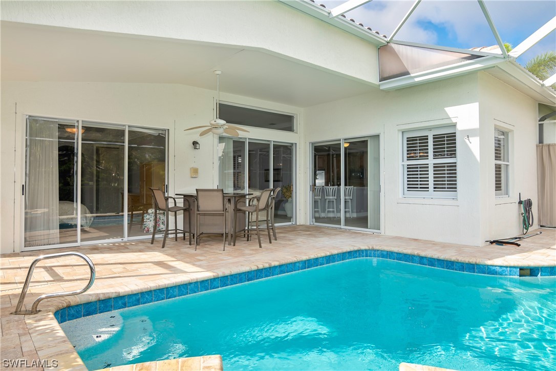 9057 Whitfield Drive Estero, FL 33928 - Photo 25 of 28 a swimming pool with outdoor seating and yard