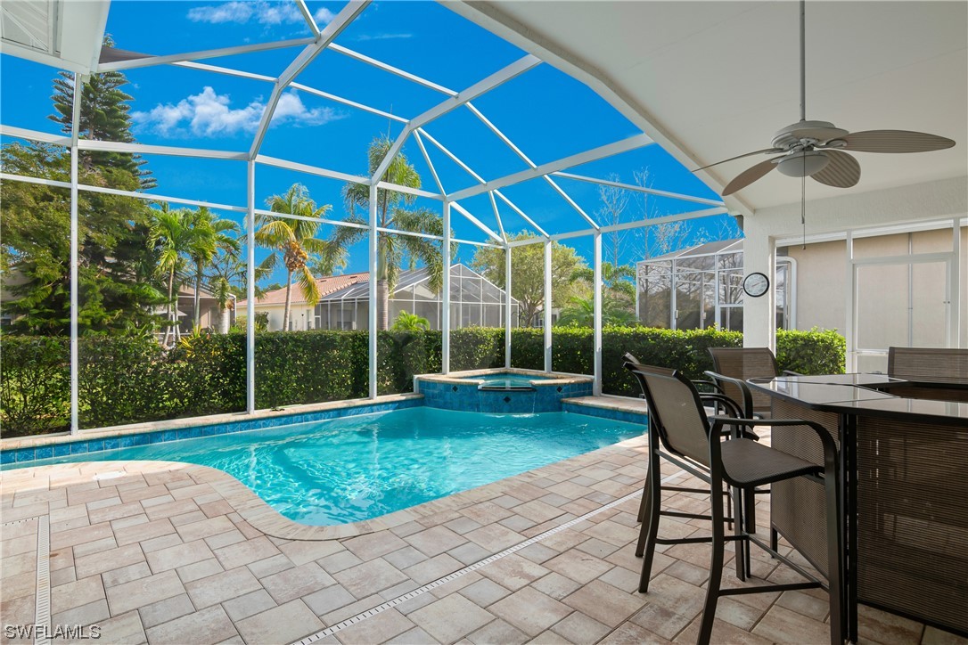 9057 Whitfield Drive Estero, FL 33928 - Photo 26 of 28 a view of a backyard with table and chairs under an umbrella