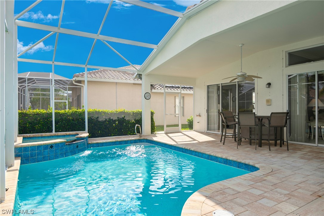 9057 Whitfield Drive Estero, FL 33928 - Photo 28 of 28 a view of a swimming pool with a patio