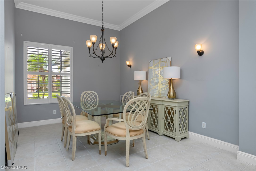 9057 Whitfield Drive Estero, FL 33928 - Photo 7 of 28 a view of a dining room with furniture a chandelier and window