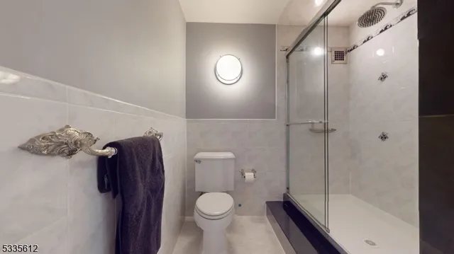 a bathroom with a toilet and a shower